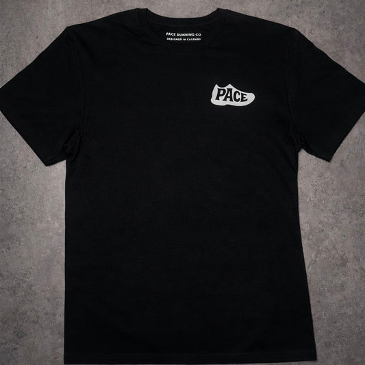 Black t-shirt with 'Pace' logo on a gray surface